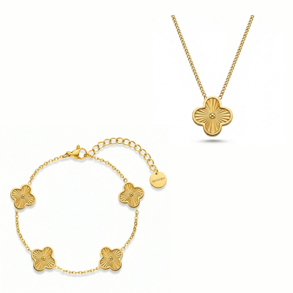 Golden Radiance Schmuck Set mit goldfarbener Kette und Armband mit strukturiertem Kleeblatt Design, hochwertig arrangiert auf reinweißem Hintergrund.