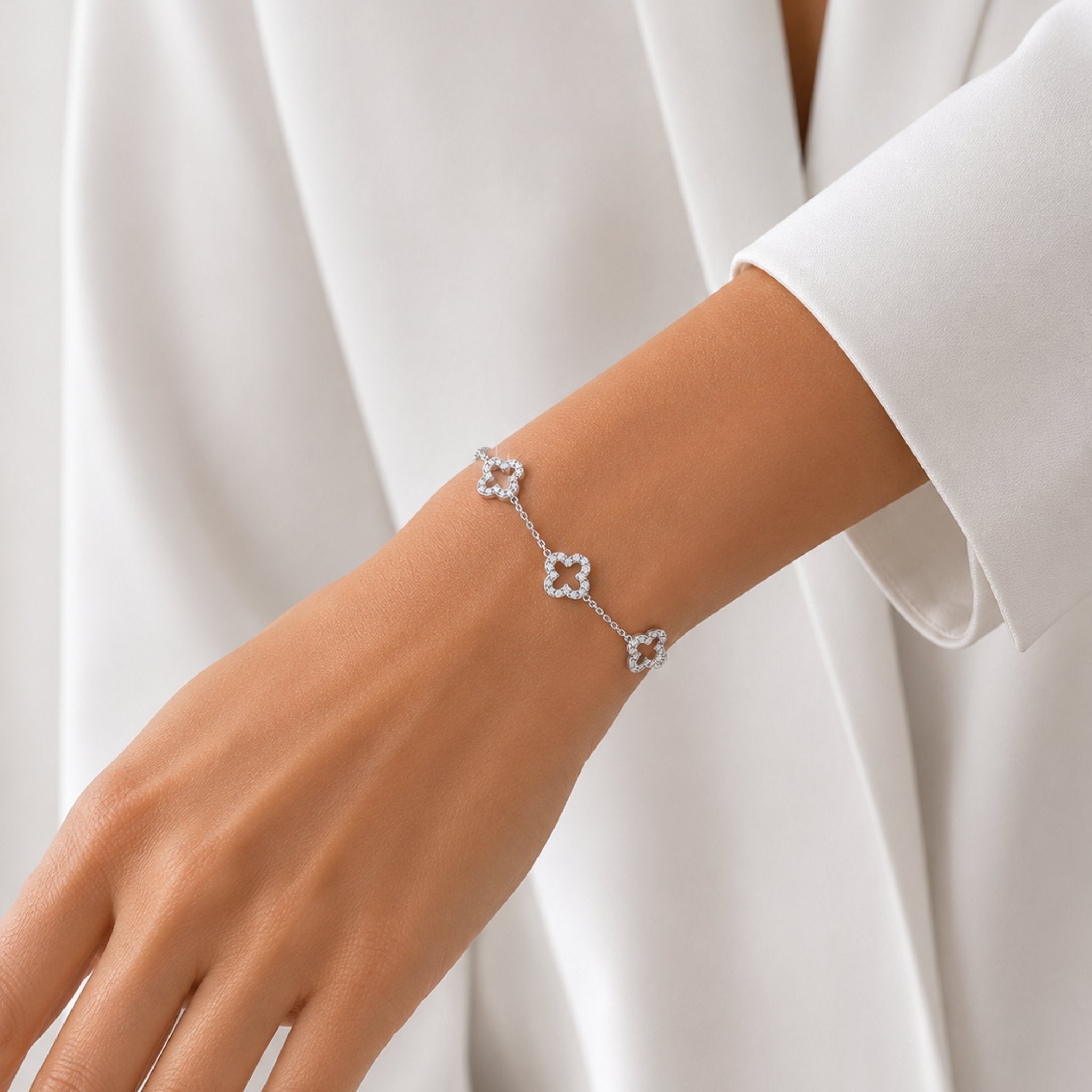 Silbernes Crystal Clover Armband mit Kleeblatt Design zu weißer Bluse kombiniert
