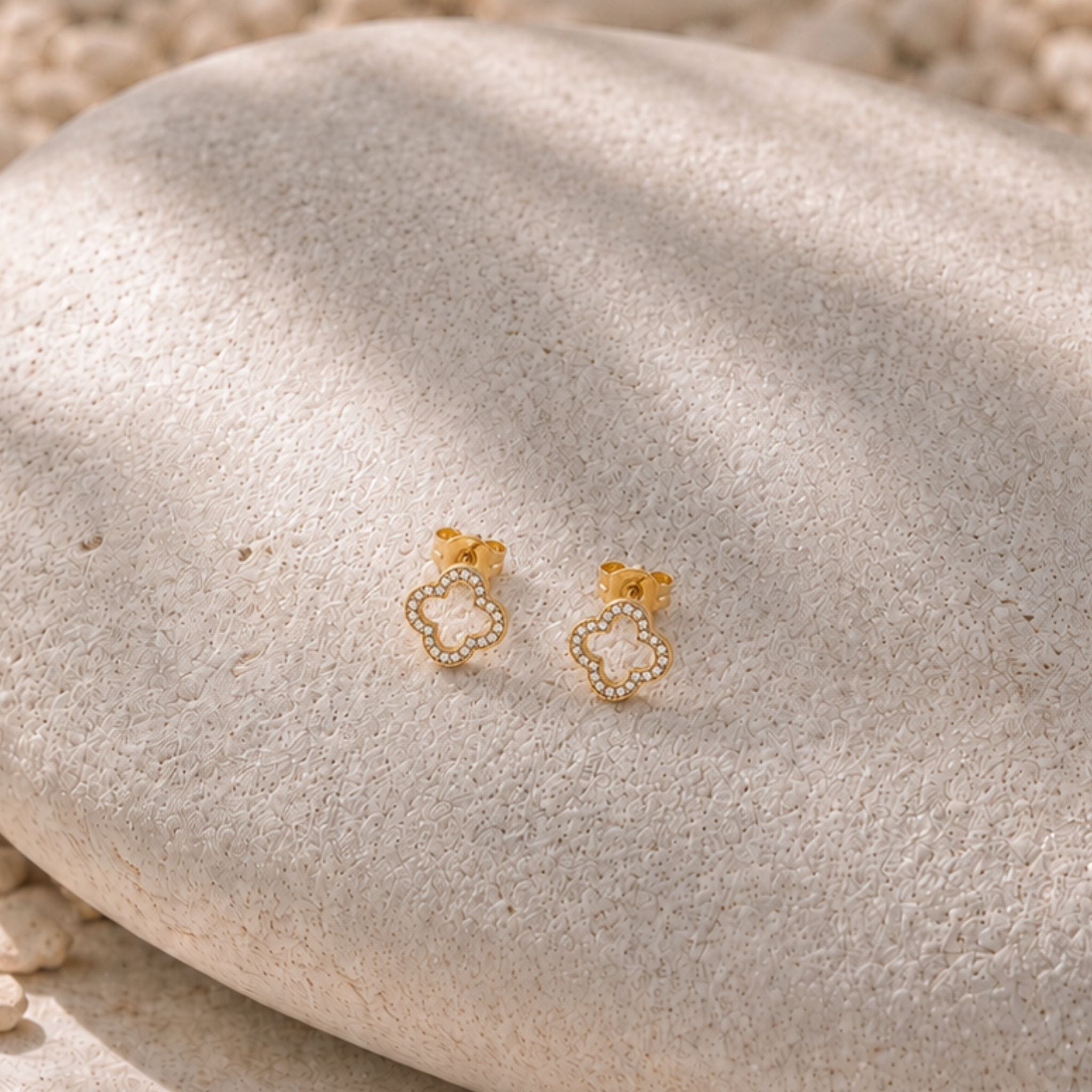 Crystal Clover Ohrringe in Gold mit glitzerndem Kleeblatt auf Naturstein