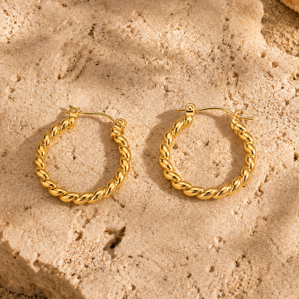 Twist Creolen Gold aus Edelstahl auf Naturstein stilvoll präsentiert